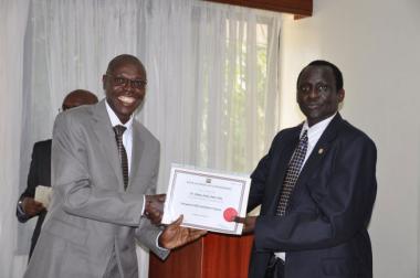  © 2014 AU-IBAR. A participant Dr. Aluma Ameri from South Sudan receives a certificate from the Chief Veterinary officer, Kenya, Dr. Juma Ngeiywa.